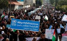 Palestinian employee of United Nations Relief and Works Agency (UNRWA) hold a sign during a protest against a U.S. decision to cut aid, in Gaza City, January 29, 2018. PHOTO BY REUTERS/Mohammed Salem