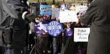 Police keep watch as protesters demonstrate in front of the U.S. Supreme Court on the morning that the court took up a major abortion case focusing on whether a Texas law that imposes strict regulations on abortion doctors and clinic buildings interferes with the constitutional right of a woman to end her pregnancy in Washington, March 2, 2016. PHOTO BY REUTERS/Kevin Lamarque