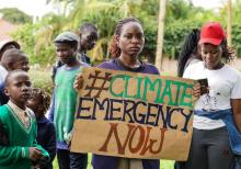 'Fridays for Future' coordinator Hilda Flavia Nakabuye holds a sign during the global 'School Strike for Climate' in Kampala, Uganda on May 24, 2019. PHOTO BY Thomson Reuters Foundation/Alice McCool