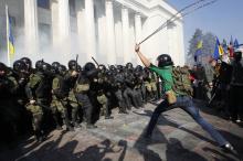 Radical protesters (R) clash with Interior Ministry and law enforcement members on the Day of Ukrainian Cossacks, marked by activists and supporters of the All-Ukrainian Union Svoboda (Freedom) Party and far-right activists and nationalists to honour the role of the movement in the history of Ukraine, during a rally near the parliament building in Kiev, October 14, 2014. PHOTO BY REUTERS/Valentyn Ogirenko