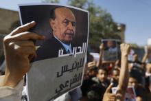 A protester holds up a poster of Abd-Rabbu Mansour Hadi during an anti-Houthi demonstration in Sanaa, February 21, 2015. PHOTO BY REUTERS/Khaled Abdullah