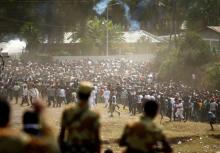 Protestors run from tear gas launched by security personnel during the Irecha, the thanks giving festival of the Oromo people in Bishoftu town of Oromia region, Ethiopia, October 2, 2016. PHOTO BY REUTERS/Tiksa Negeri
