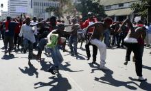 Protestors take to the streets of Malawi's commercial capital Blantyre, July 20, 2011. Riots broke out in several cities in Malawi on Wednesday after police tried to disperse protesters demanding the resignation of President Bingu wa Mutharika, whom they accuse of ignoring civil liberties and trashing the economy. PHOTO BY REUTERS/Eldson Chagara