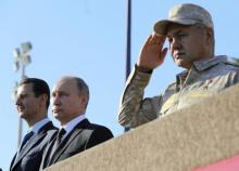 Russian President Vladimir Putin (C), Defence Minister Sergei Shoigu (R) and Syrian President Bashar al-Assad visit the Hmeymim air base in Latakia Province, Syria, December 11, 2017. PHOTO BY REUTERS/Sputnik/Mikhail Klimentyev