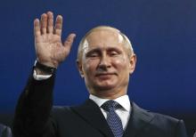 Russia's President Vladimir Putin waves during the closing ceremony for the 2014 Sochi Winter Olympics