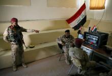 Iraqi soldiers work at a radio station at Makhmour base, Iraq, April 17, 2016. PHOTO BY REUTERS/Ahmed Jadallah
