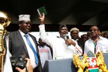 Kenyan opposition leader Raila Odinga (C) of the National Super Alliance (NASA) is flanked by lawyer Miguna Miguna (L) and James Orengo as he takes a symbolic presidential oath of office in front of his supporters in Nairobi, Kenya, January 30, 2018. PHOTO BY REUTERS/Baz Ratner