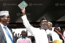 Kenyan opposition leader Raila Odinga of the National Super Alliance (NASA) holds a bible as he takes a symbolic presidential oath of office in Nairobi, Kenya, January 30, 2018. PHOTO BY REUTERS/Baz Ratner