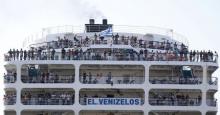Syrian refugees are seen onboard passenger ship "Eleftherios Venizelos" as the ship arrives at the port of Piraeus near Athens, Greece, August 20, 2015. The ship was heading to the Greek mainland from islands in the Aegean Sea on Wednesday amid confusion over its final destination and the fate of passengers. PHOTO BY REUTERS/Stoyan Nenov
