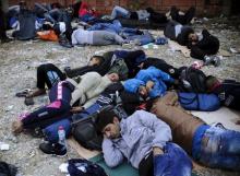Migrants sleep at transit camp in Gevgelija, Macedonia, after entering the country by crossing the border with Greece, September 24, 2015. PHOTO BY REUTERS/Ognen Teofilovski