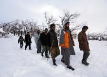 Relatives of avalanche victims return after conducting a search for the victims in Panjshir province, February 25, 2015. PHOTO BY REUTERS/Omar Sobhani