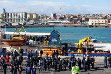 CATANIA, Italy (Reuters) - Migrants forced to remain on board the ship that rescued them off the coast of Libya almost two weeks ago stepped onto dry land in Sicily on Thursday, with Italy's government promising to continue to block charity ships from its ports.  The Sea-Watch 3, run by a German humanitarian group, docked in the port of Catania to disembark the 47 people, including 15 minors, that it picked up on Jan. 19.  After hugging crew members, the minors disembarked first. The migrants then boarded b