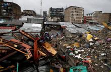 A general view shows rescue workers searching for residents feared trapped in the rubble of a six-storey building that collapsed after days of heavy rain in Nairobi, Kenya, May 1, 2016. PHOTO BY REUTERS/Thomas Mukoya