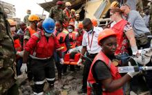 Kenya Red Cross rescuers evacuate a woman from the rubble of a six-storey building that collapsed last Friday after days of heavy rain, in Nairobi, Kenya, May 5, 2016. PHOTO BY REUTERS/Thomas Mukoya