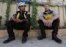 Syrian rescue worker Samir Salim sits next to his colleague Ahmed Rashid during an interview with Reuters in Azaz, Syria, July 8, 2018. PHOTO BY REUTERS/Khalil Ashawi