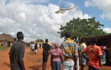 Residents look at a police helicopter patrolling near the closed house, where Italian volunteer for the Italian charity Africa Milele lived before she was seized, in Chakama trading centre of Magarini, Kilifi County, Kenya, November 21, 2018. PHOTO BY REUTERS/Stringer