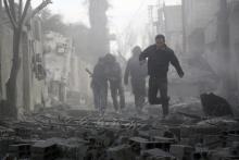 Residents look for survivors amid debris of collapsed buildings after what activists said were air strikes by forces loyal to Syria's President Bashar al-Assad in Marj Al Sultan, in the eastern Damascus suburb of Ghouta, February 27, 2015. PHOTO BY REUTERS/Amer Almohibany