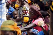 A returnee woman drinks a beverage while sitting at a registration centre in Geidam stadium, Nigeria May 6, 2015. PHOTO BY REUTERS/Afolabi Sotunde
