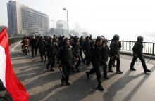 Riot police are seen on October bridge during clashes with anti-government protesters and members of the Muslim Brotherhood, near Tahrir Square in downtown Cairo, on the third anniversary of Egypt's uprising