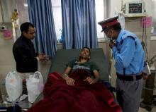 Rishi Khanal, 28, who was pulled out from a collapsed residential building following Saturday's earthquake, speaks to a security guard at a hospital in Kathmandu, Nepal, April 29, 2015. PHOTO BY REUTERS/Danish Siddiqui