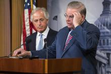 U.S. Senate Foreign Relations Committee Chairman Robert Menendez (D-NJ) (R) and ranking member Senator Bob Corker (R-TN) (L) hold a news conference after a Senate vote on an aid package for Ukraine at the U.S. Capitol in Washington