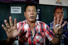 President elect Rodrigo "Digong" Duterte talks to the media before casting his vote at a polling precinct for national elections at Daniel Aguinaldo National High School in Davao city in southern Philippines, May 9, 2016. PHOTO BY REUTERS/Erik De Castro