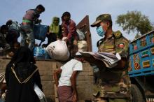Newly arrived Rohingya refugees climb on a truck to get registered after crossing the Bangladesh-Myanmar border at a relief centre in the Teknaf area, Bangladesh, November 23, 2017. PHOTO BY REUTERS/Susana Vera