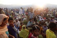 The sun rises as thousands of Rohingya refugees who fled from Myanmar a day before wait by the road where they spent the night between refugee camps, near Cox's Bazar, Bangladesh, October 10, 2017. PHOTO BY REUTERS/Damir SagolJ