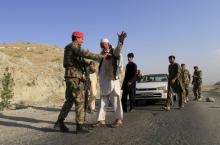 Afghan National Army soldiers (ANA) inspect passengers at a checkpoint on the outskirts of Jalalabad province, eastern Afghanistan, June 29, 2015. PHOTO BY REUTERS/Parwiz