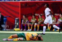 Australia forward Samantha Kerr (20) lay on the ground injured after being elbowed in the face during the second half against as Nigeria defender Ugo Njoku (back) runs past in a Group D soccer match in the 2015 FIFA women's World Cup at Winnipeg Stadium, Winnipeg, Manitoba, CAN, Jun 12, 2015. PHOTO BY/USA TODAY Sports/Bruce Fedyck