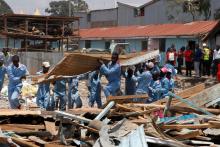 Rescue workers go through the rubble at the site of a collapsed school classroom, in Nairobi, Kenya, September 23, 2019. PHOTO BY REUTERS/Njeri Mwangi
