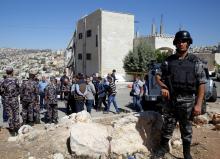 Security forces gather near a damaged building at the city of Salt, Jordan, August 12, 2018. PHOTO BY REUTERS/Muhammad Hamed