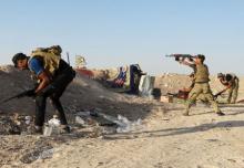 Iraqi security forces fire their weapons during clashes with Islamic State militants on the outskirts of Ramadi June 15, 2015. PHOTO BY REUTERS/Stringer