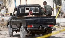 A security officer guards a suspected member of the al Shabaab, who was detained near the Mogadishu port after a suicide car bomb went off at the entrance of the port, in Mogadishu, Somalia, December 11, 2016. PHOTO BY REUTERS/Feisal Omar