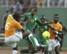 Senegal's Ricardo William Faty (2nd L) fights for the ball with with Ivory Coast's Yaya Toure (L) 