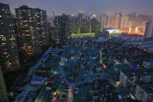 A night view of the old houses surrounded by new apartment buildings at Guangfuli neighbourhood in Shanghai, China, April 10, 2016. PHOTO BY REUTERS/Aly Song