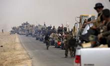Shi'ite paramilitaries riding military vehicles travel from Lake Tharthar toward Ramadi to fight against Islamic state militants, west of Samarra, Iraq May 27, 2015. PHOTO BY REUTERS/Stringer