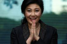 Ousted former Thai prime minister Yingluck Shinawatra greets supporters as she arrives at the Supreme Court in Bangkok, Thailand, August 1, 2017. PHOTO BY REUTERS/Athit Perawongmetha