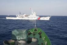 A ship (top) of Chinese Coast Guard is seen near a ship of Vietnam Marine Guard in the South China Sea, about 210 km (130 miles) off shore of Vietnam, May 14, 2014. PHOTO BY REUTERS/Nguyen Minh