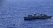 Able Seaman Marine Technician Matthew Oxley stands aboard the Australian Navy ship the HMAS Success looking for debris in the southern Indian Ocean during the search for missing Malaysian Airlines Flight MH370 in this picture released by the Australian Defence Force