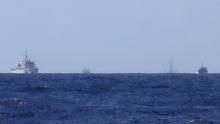 Chinese ships are seen on the horizon guarding the Haiyang Shiyou 981, known in Vietnam as HD-981, oil rig (2nd R) in the South China Sea, July 15, 2014. PHOTO BY REUTERS/Martin Petty
