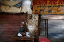A muslim meat shop owner looks on outside his closed shop in Gurugram, Haryana, India, March 29, 2017. PHOTO BY REUTERS/Cathal McNaughton