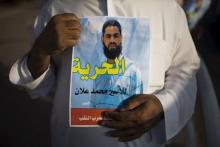 A Bedouin demonstrator holds a sign during a protest in the southern town of Rahat, Israel, in support of Islamic Jihad activist Mohammed Allan, who is in the ninth week of a hunger strike against his detention without trial, August 18, 2015. PHOTO BY REUTERS/Amir Cohen