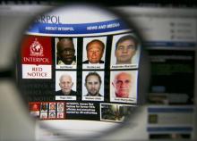 The homepage of the Interpol website is seen through a magnifying glass in this picture illustration taken in Berlin, Germany, June 3, 2015. PHOTO BY REUTERS/Pawel Kopczynski