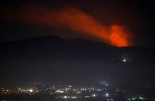 Smoke rises past a mountain as seen from Damascus countryside, Syria, December 25, 2018. PHOTO BY REUTERS/Omar Sanadiki