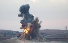 Smoke and flames rise over a hill near the Syrian town of Kobani after an airstrike, as seen from the Mursitpinar crossing on the Turkish-Syrian border in the southeastern town of Suruc in Sanliurfa province, October 23, 2014. PHOTO BY REUTERS/Kai Pfaffenbach