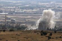 Smoke rises during fighting in the village of Ahmadiyah in Syria, as seen from the Israeli side of the border fence between Syria and the Israeli-occupied Golan Heights, June 17, 2015. PHOTO BY REUTERS/Baz Ratner