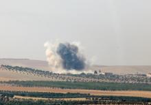 Smoke rises from the Syrian border town of Jarablus as it is pictured from the Turkish town of Karkamis, in the southeastern Gaziantep province, Turkey, August 24, 2016. PHOTO BY REUTERS/Stringer