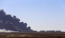 Black smoke billows out of a storage oil tank at the port of Es Sider in Ras Lanuf, December 28, 2014. PHOTO BY REUTERS/Stringer