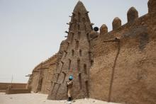 A UN peacekeeper from Burkina Faso stands guard at the Djinguereber mosque, built in the 14th century, during a visit by a UN delegation on election day in Timbuktu, Mali, July 28, 2013. PHOTO BY REUTERS/Joe Penney